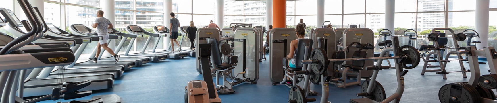 Personas haciendo ejercicio en una moderna sala de aparatos